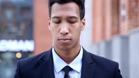 Portrait-of-Sad-African-Businessman-Looking-at-Camera