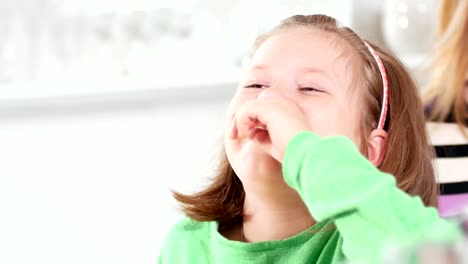 Baby-girl-laughing-pointing-finger-and-having-fun-at-studio