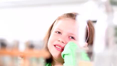 Portrait-of-little-girl-smiling-hiding-her-face-with-her-hand-at-studio