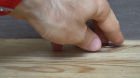 Business-concept---man-hand-collect-euro-coins-on-the-wooden-table.