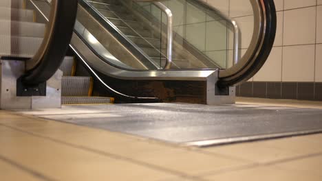 Man-steps-of-an-escalator-onto-the-floor-below