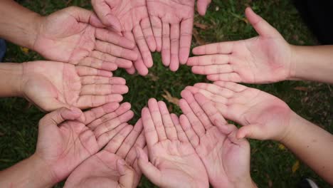 Hand-give-a-red-heart-to-many-hands-of-people