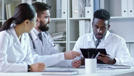 Diverse-Colleagues-in-Lab-Coats-at-Meeting