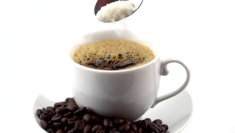 Pouring-sugar-into-black-coffee