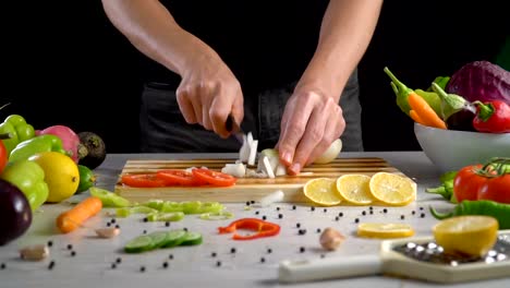 Man-is-chopping-onion-in-the-kitchen-in-slow-motion