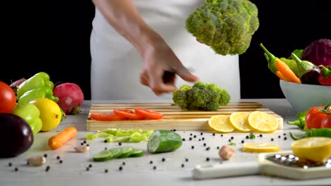 Chef-is-chopping-fresh-broccoli-in-the-kitchen