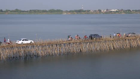 Traffic-jam-on-the-bamboo-bridge;-motorbikes,-cars,-and-people-on-foot-crossing-it-(-time-lapse)