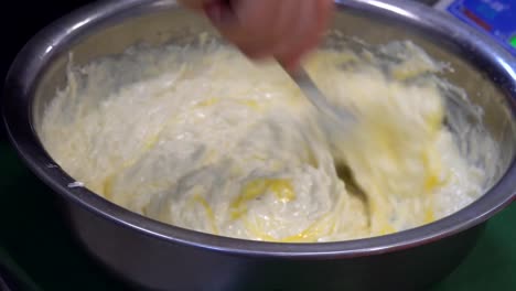 A-man's-hand-stirring-white-sauce.-The-chef-prepares-the-sauce-and-cheese.-Food.-Kitchen.-healthy-diet.-Close-up.-HD