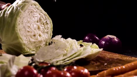 Cutting-cabbage-with-knife-on-the-wood.-Slow-motion