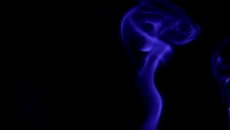 Blue-Steam-Rises-from-up.-Blue-smoke-over-a-black-background.-Smoke-slowly-floating-through-space-against-black-background.-Slow-Motion.