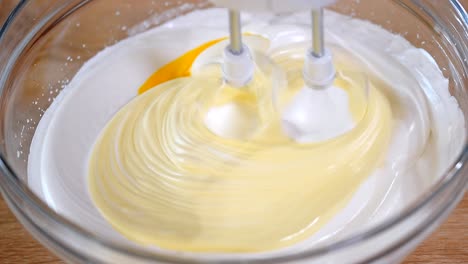 Whipping-cream-with-electric-mixer.-Home-bakery.-Ingredients-for-baking-at-home.-Beating-eggs-with-hand-mixer.