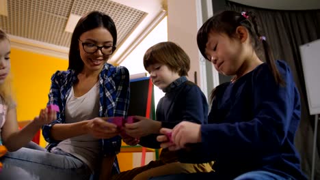 Teacher-with-diverse-kids-creating-toys-at-lesson