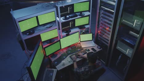 Hacker-using-computer-with-multiple-monitors