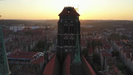 Gdansk-old-city-in-the-rays-of-the-rising-sun,-aerial-view-of-the-old-city-streets