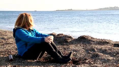 Sad-woman-sitting-at-the-seaside