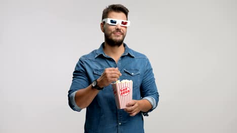 Young-man-wearing-pair-of-3D-glasses-and-laughing