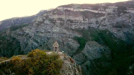 A-small-chapel-on-the-mountain-edge-against-at-the-morning.-Aerial-shot