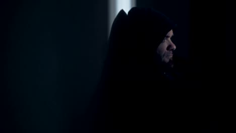 Portrait-of--depressed-hooded-man-in-the-darkness