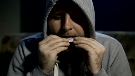 Close-up-male-portrait-rolling-marijuana-joint