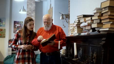 Senior-man-read-book-together-with-granddaughter