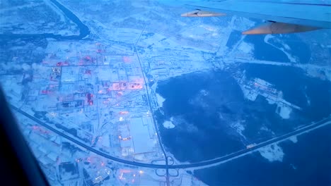 Airplane-flying-over-snowy-suburb-in-the-early-morning-FullHD