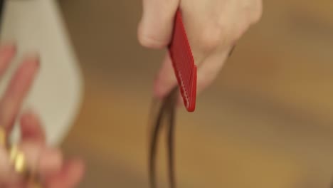 Hand-hairdresser-cutting-hair-tips-during-woman-haircut-with-scissors-in-hairdressing-salon.-Close-up-hairstylist-making-female-hair-cut-in-beauty-studio