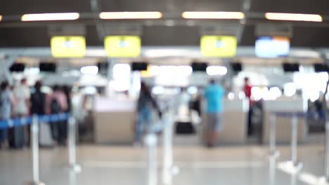 Unscharfe-Aufnahmen-der-Passagiere-zu-Fuß-zum-Check-in-Schalter-am-Flughafen-terminal.-4K-Video-mit-defokussierten-Wirkung.