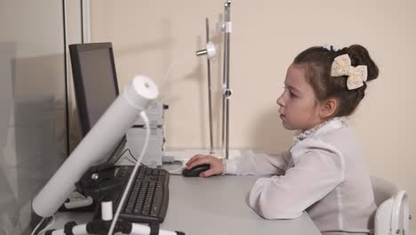 Cute-pupil-sitting-at-computer