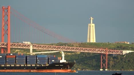 Cargo-ship-under-the-bridge.-15.05.2018-Lisbon,-Portugal