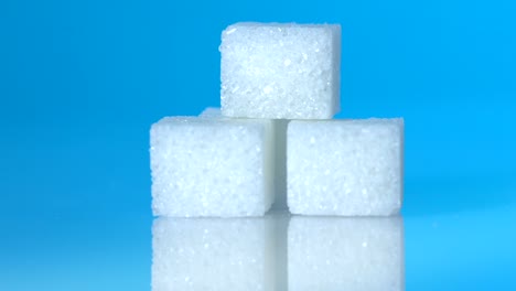 Table-top-shot-Group-of-Sugar-cubes-vary-position-on-light-blue-background