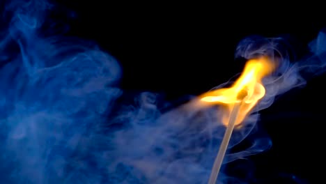 Burning-match-on-a-black-background-in-slow-motion