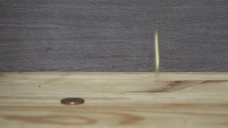 Business-concept---man-hand-collect-euro-coins-on-the-wooden-table.