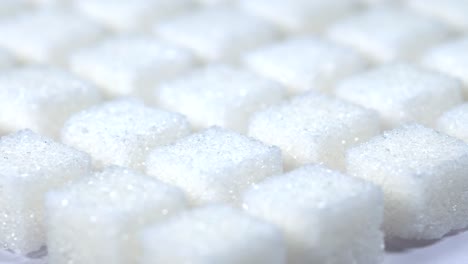 Table-top-shot-Group-of-Sugar-cubes-vary-position-on-light-blue-background