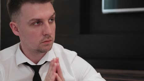 Portrait-of-businessman-regretting-about-something-with-hands-folded-praying