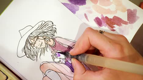 artist-drawing-a-sketch-with-the-watercolors-paints