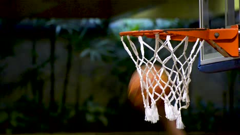 People-training-basketball-speed-dribble.-Basketball-net-close-up.-Flat-plane.-Side-view