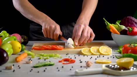 Man-is-chopping-onion-in-the-kitchen-in-slow-motion