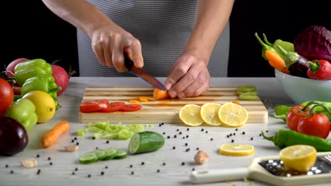 Chef-is-cutting-vegetables-in-the-kitchen,-slicing-carrot