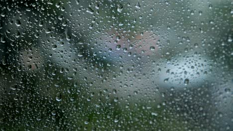 blurred-traffic-view-through-a-car-windscreen-covered-in-rain-for-background.