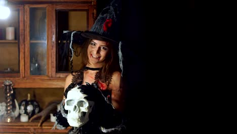 Halloween-witch-with-a-staff-of-a-human-skull.-Smiling-wickedly