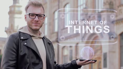 Smart-young-man-with-glasses-shows-a-conceptual-hologram-Internet-of-things