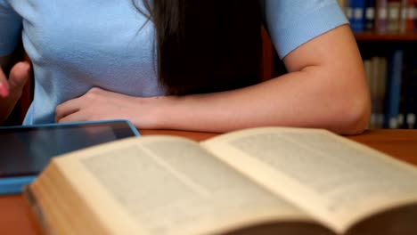 pretty-girl-using-computer-tablet-in-the-library-or-in-the-office.