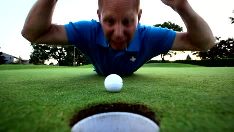 Golfer-is-upset-that-his-ball-won't-go-into-the-hole.-Close-up-shot.