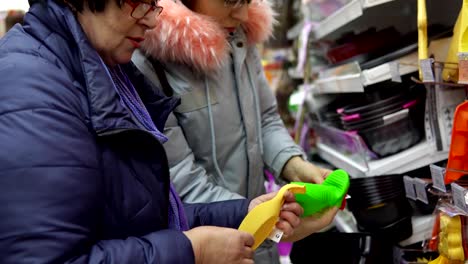 Two-female-customers-choose-kitchen-accessories-in-the-hardware-store.