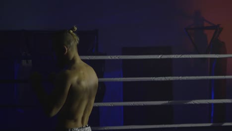 boxing-training,-sportsman-works-off-beats-in-ring-in-twilight-before-fight