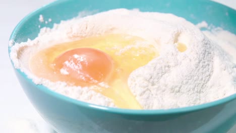 Egg-falls-into-flour-slow-motion-shot