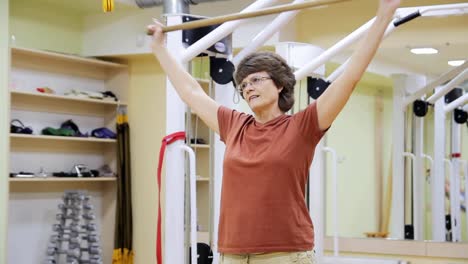 Senior-woman-doing-exercises-in-fitness-room.