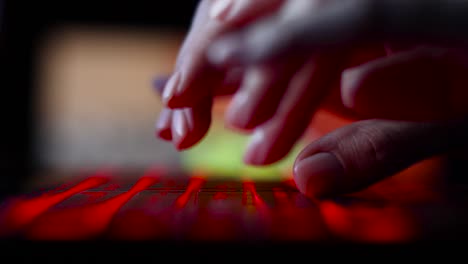 hacker-girl's-hand-typing-on-keyboard-with-red-backlight