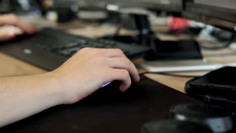 Close-up-of-man's-hand-working-at-computer.-Male-uses-computer-mouse-for-work