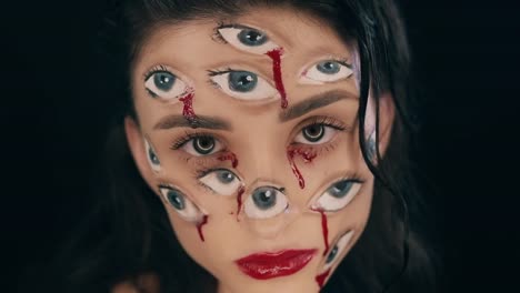 Art-Halloween-makeup,-woman-has-many-eyes-on-a-face